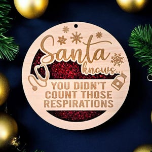 May include: Wooden Christmas ornament with the text "Santa knows... You didn't count those respirations." The ornament has a red glitter center and snowflake and stethoscope designs. Gold ornaments and greenery surround the ornament.