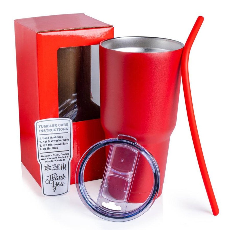 May include: A red stainless steel tumbler with a lid and straw. The tumbler is in a red box with a clear window. The box has a label with care instructions. The label says "Tumbler Care Instructions: 1. Hand Wash Only 2. Not Dishwasher Safe 3. Not Microwave Safe 4. Do Not Drop Stainless Steel, Double Wall Vacuum Sealed & Powder Coated! Hot or Cold Drinks Thank You"