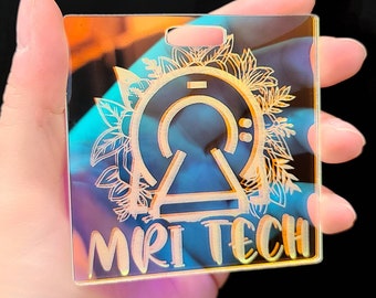 May include: A clear iridescent acrylic keychain with a stylized MRI machine design and the text "MRI TECH" in a decorative font.