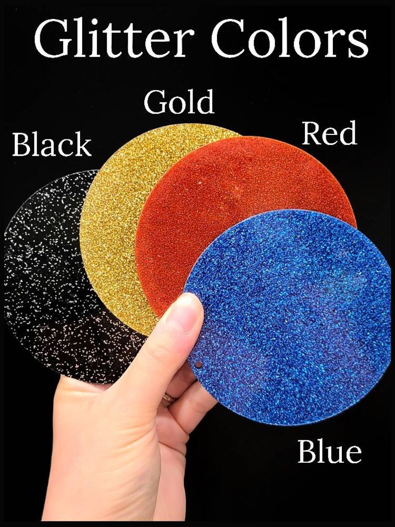May include: The image displays four circular glitter samples in black, gold, red, and blue, held against a black background. The text "Glitter Colors" is at the top, with each color labeled below its respective sample.