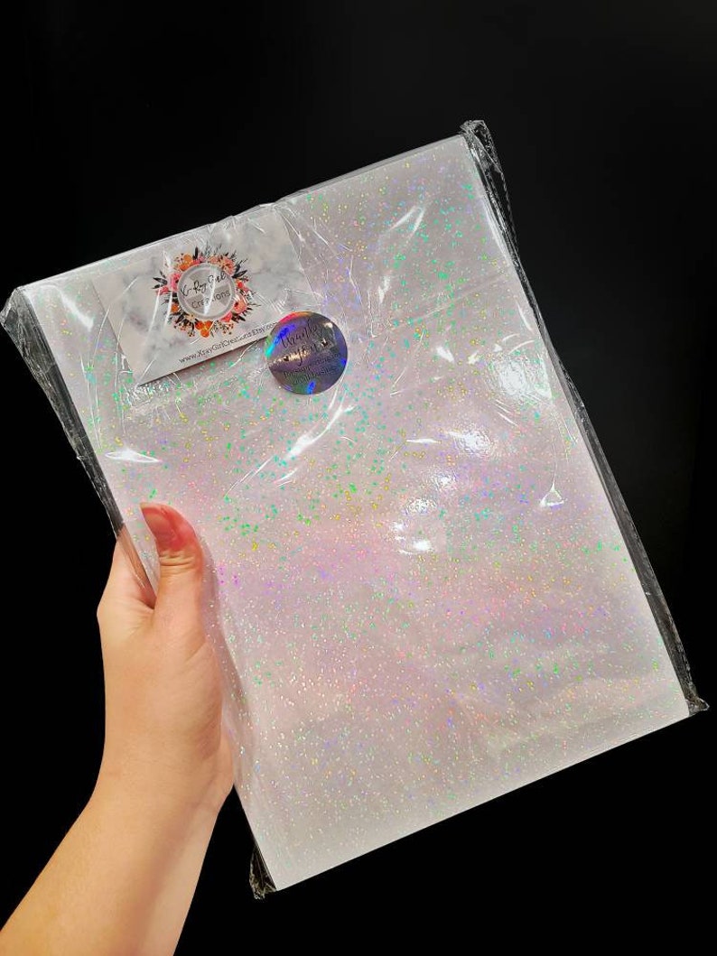 May include: A sheet of iridescent white glitter paper with a small sticker that says "Beautifully Crafted" on it.