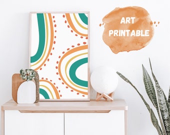 Puede incluir: Una impresión de arte imprimible con formas abstractas en verde azulado, amarillo y naranja con lunares rojos sobre un fondo blanco. La impresión está enmarcada y se muestra en un estante con una planta y una lámpara de luna.