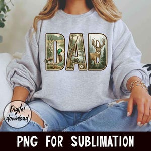 May include: A light gray sweatshirt with the word "DAD" in a nature-themed design. The letters are filled with images of a duck, rifles, and a deer. The words "Digital download" and "PNG FOR SUBLIMATION" are also visible.