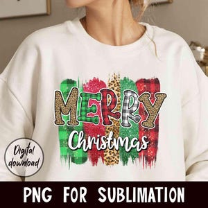 May include: White sweatshirt with a colorful "Merry Christmas" design featuring plaid, leopard print, and glitter accents.