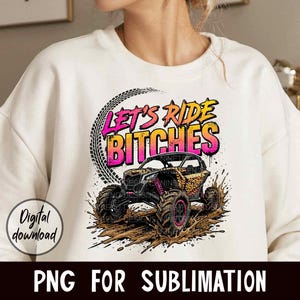 May include: Cream-colored sweatshirt with a graphic of an off-road vehicle in mud, featuring the text "LET'S RIDE BITCHES." The design includes tire tracks and leopard print accents. The words "Digital download" and "PNG FOR SUBLIMATION" are also visible.