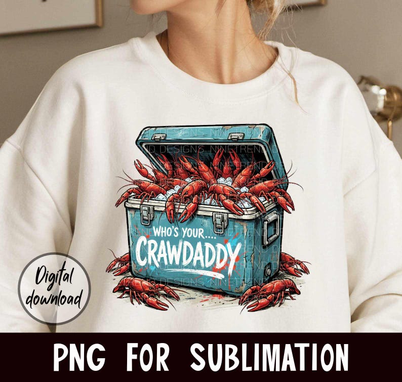 Puede incluir: Sudadera blanca con un gr&aacute;fico de una nevera azul desbordante de cangrejos rojos. La nevera tiene el texto "WHO'S YOUR...CRAWDADDY". Tambi&eacute;n son visibles las palabras "Digital download" y "PNG FOR SUBLIMATION".