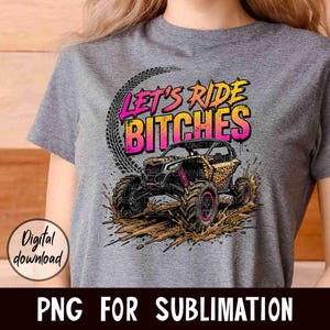 May include: Gray t-shirt featuring a graphic of an off-road vehicle splashing through mud. The design includes the text "LET'S RIDE BITCHES" in pink and yellow, with tire tracks and a "Digital download" graphic.