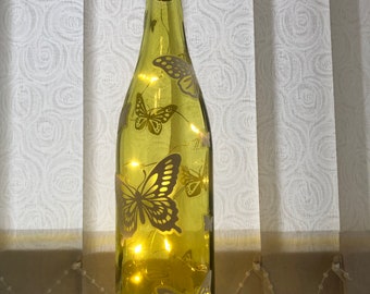 Enciende la botella de mariposa decorativa