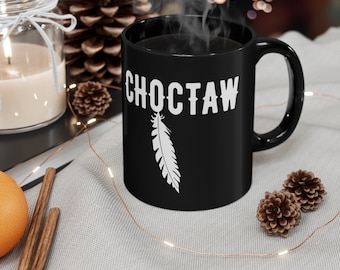 May include: Black coffee mug with a white feather design and the word "Choctaw" in white lettering.
