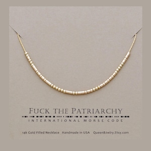 Custom morse code necklace featuring dainty beads representing 'FUCK THE PATRIARCHY' in Morse code.  Below, the text reads '14k Gold Filled Necklace', 'Handmade in USA', and 'QueenBJwlry.Etsy.com'.