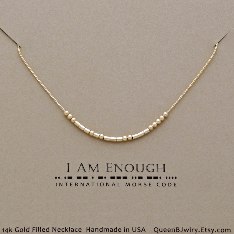 Unique Jewelry for women, Dainty gold filled necklace with beads that spell out the message 'I AM Enough' in morse code. '14k Gold Filled Necklace', 'Handmade in USA', and 'QueenBJwlry.Etsy.com'.