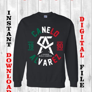 May include: Black sweatshirt with a white graphic of a boxing logo with the text "CANELO 19 90 4-DIVISION WORLD CHAMPION ALVAREZ" in a circle with green, white, and red accents.
