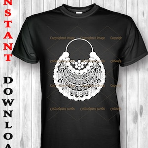May include: A black t-shirt with a white design of a large, ornate, circular pendant with a loop at the top. The design is intricate and detailed, featuring swirls, leaves, and beads.
