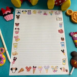 May include: A white sheet of paper with blue lines and a variety of colorful cartoon images of food and characters. The text "I'm here for the snacks" is printed on the paper.