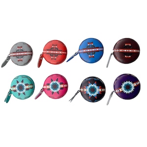 May include: Set of ten colorful tape measures with geometric patterns. Each tape measure has a different color and pattern, including turquoise, red, blue, purple, and brown. The tape measures are all round and have a metal ring on the top.