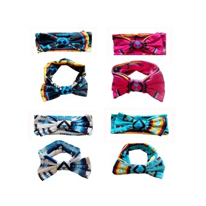 May include: A collection of eight headbands with a bow design. The headbands feature various patterns and colors, including black, pink, blue, and turquoise, with geometric and tribal-inspired designs. The headbands are displayed against a white background.