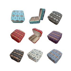 May include: A collection of small, square jewelry boxes in various colors, including teal, red, purple, and gray. Each box features a patterned design and opens to reveal compartments for storing jewelry. Some boxes are open, showcasing the interior.