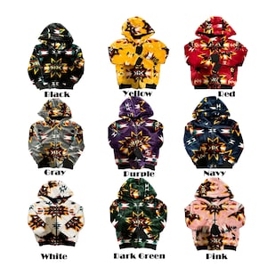 May include: Nine hooded zip-up jackets in various colors: black, yellow, red, gray, purple, navy, white, dark green, and pink. Each jacket features a Native American-inspired geometric pattern in contrasting colors. The jackets have black cuffs and a black bottom hem.