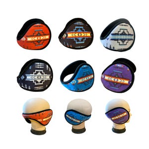 May include: Eight pairs of ear warmers with different geometric patterns in shades of orange, blue, purple, black, and white. The ear warmers are made of fleece and have a black band.