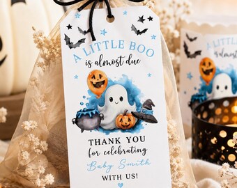 May include: A white rectangular gift tag tied with a black string to a sheer beige organza bag. The tag features the text A LITTLE BOO is almost due, a watercolour ghost, a pumpkin balloon, a cauldron, and a witch hat, plus THANK YOU for celebrating Baby Smith WITH US!