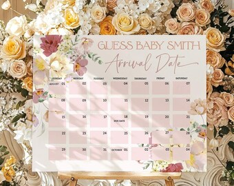 May include: A baby arrival date calendar on a wooden easel, with the text "Guess Baby Smith Arrival Date." The calendar is light pink with floral accents. The background features an abundance of flowers in shades of yellow, peach, and white.