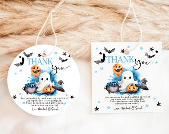 May include: Two round and square thank you tags featuring a cute ghost, cauldron, and pumpkins. The text reads "Thank You" in a blue and white colour scheme. The text also says "for creeping by and casting spells of joy upon our little pumpkin. Your presence and gifts have bewitched us dearly! Love, Mukul & Sarah."