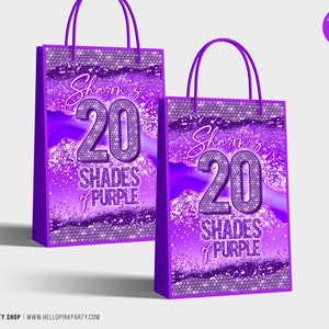 May include: Two purple gift bags with white handles. The bags feature the text "Sharon's 20 Shades of Purple" in a decorative font. The design includes a sequined pattern and a marbled background.