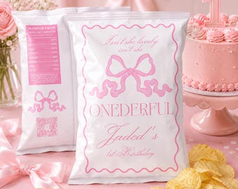 May include: White chip bags with pink text and a bow design. The bags read "Isn't she lovely isn't she" and "ONEDERFUL Jaded's 1st Birthday". A pink cake with a crown and the number 1 is in the background. Potato chips are scattered on the table.