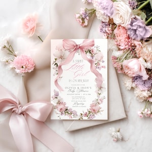May include: A baby shower invitation featuring a floral wreath and a pink ribbon. The text reads "A Sweet Little Girl Is On Her Way!" with details for Olivia & Jhon's Baby Shower, August 20th at 5 PM. The design incorporates soft pink and white flowers.