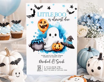 May include: A rectangular baby shower invitation card featuring a white background with blue watercolor accents, a central white ghost, an orange jack-o'-lantern balloon, a black cauldron, a small pumpkin, and a black witch hat with blue trim.
