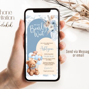 May include: A blue and white phone screen with a baby shower invitation. The invitation features a teddy bear holding balloons, a floral design, and the text "We Can Bearly Wait". The invitation is for a baby shower honoring Ashlynn and celebrating baby Tyler Blue. The shower will be held on Saturday, August 22nd at 5:00pm at Jhonson's Residence, 1234 Sweet Baby Road, Dallas TX 12345. The invitation also includes information about where to register for gifts: Target and Amazon.