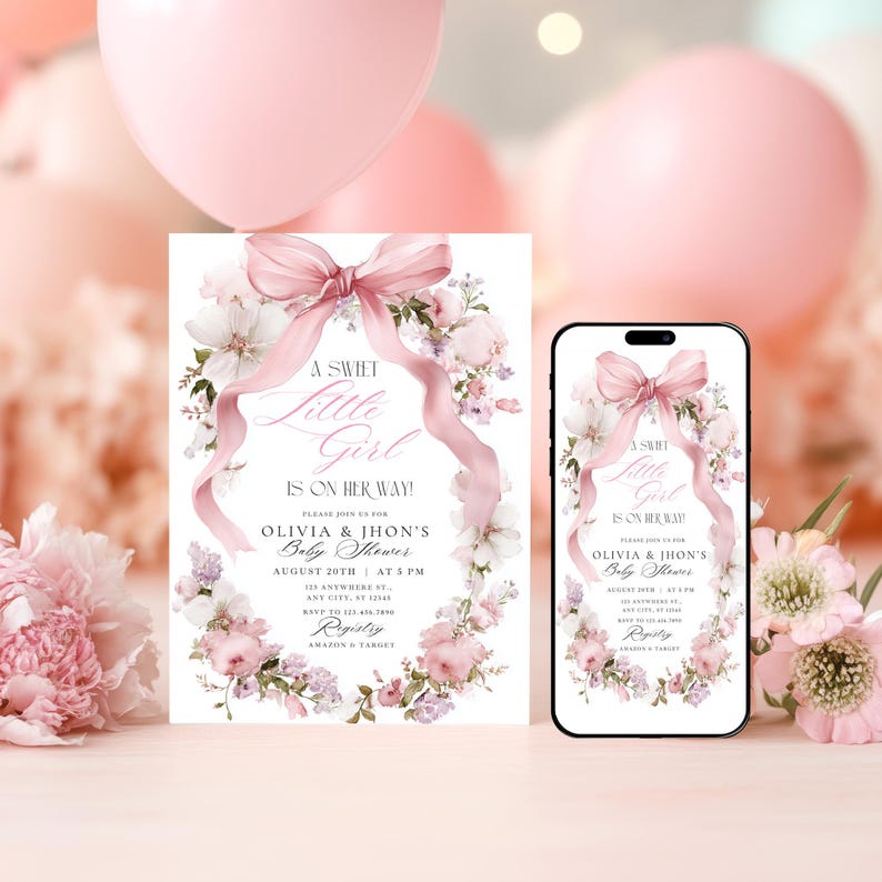 May include: A baby shower invitation and a smartphone showing the same design. The invitation and phone screen display a floral wreath with a pink bow and the text "A Sweet Little Girl Is On Her Way!" The invitation includes event details.