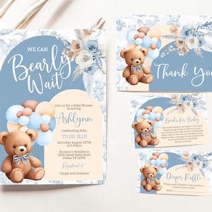 May include: Blue and beige baby shower invitation with a teddy bear holding balloons. The invitation says "We Can Bearly Wait" and includes the baby's name, Ashlynn, and the date and time of the shower. The invitation also includes a thank you card, a book request card, and a diaper raffle card.