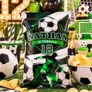 May include: A rectangular snack bag featuring a football theme with a black and white football graphic, a silhouette of a football player, and the text NATHAN IS TURNING 12. The design uses a green and black colour palette with geometric patterns.