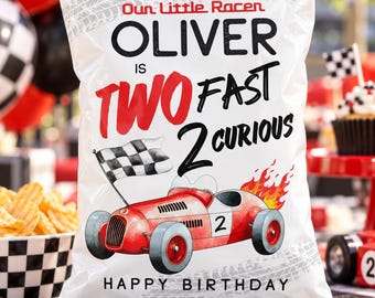 May include: A white snack bag featuring a black and white checkered border, a red race car with the number 2, a checkered flag, and the text: Our Little Racer OLIVER IS TWO FAST 2 CURIOUS HAPPY BIRTHDAY. The design includes tire track patterns.