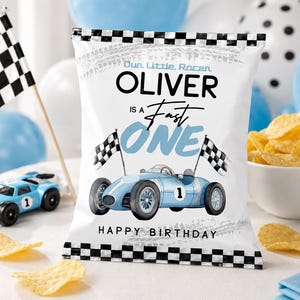 May include: A white chip bag with a black and white checkered border and a race car theme. The bag features a light blue race car illustration, checkered flags, and the text "Oliver is a Fast One" and "Happy Birthday."