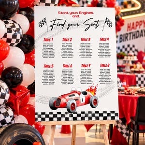 May include: A white seating chart sign with a race car theme, featuring the text Start your Engines and Find your Seat, a red race car illustration, and a black and white checkered border, displayed on a wooden easel for a party event.
