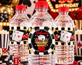 May include: Three clear plastic water bottles with red caps, each featuring a custom label with a casino theme. The labels display playing cards, dice, and the text "Deshaun's CASINO NIGHT 50" in a circular black and white poker chip design.