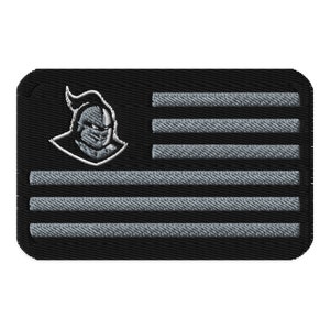 May include: A black and gray embroidered patch featuring a knight's head with a helmet and a gray and white American flag design.