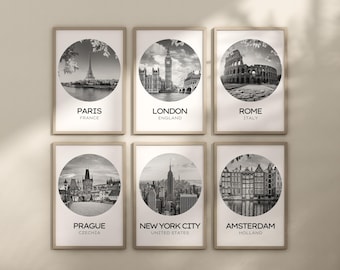 May include: A set of six framed wall art prints in light wood frames, each featuring a circular black and white photograph of a city landmark: Paris, London, Rome, Prague, New York City, and Amsterdam, with the city and country name printed below.