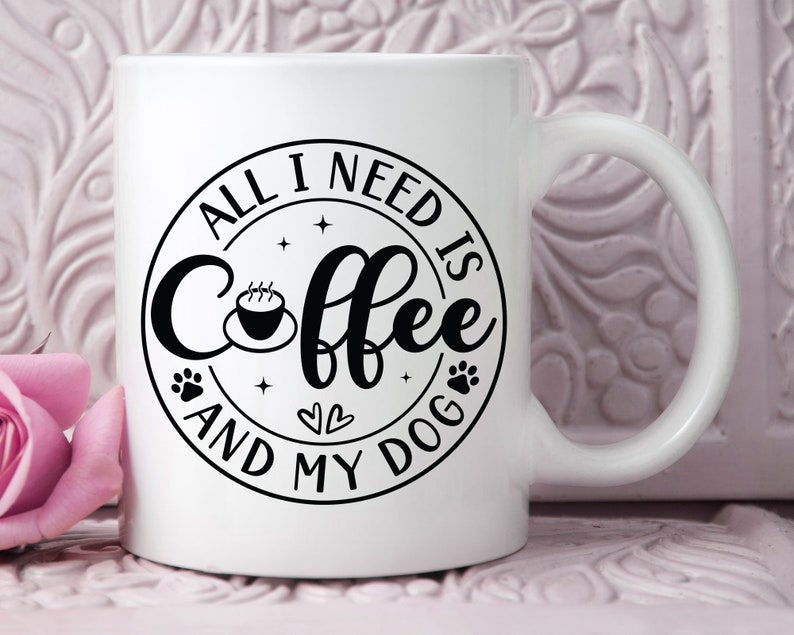May include: White ceramic coffee mug with a black circle design that says "All I need is coffee and my dog" with a paw print, a heart, and a coffee cup graphic.