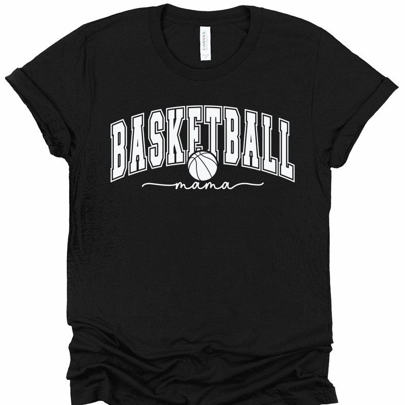 May include: Black t-shirt with white text that reads "Basketball mama" with a basketball graphic.
