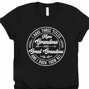May include: Black t-shirt with a white circle graphic that says "I have three titles: Mom, Grandma, and Great Grandma, and I rock them all".