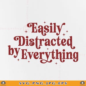 May include: A digital graphic design featuring the dark red text "Easily Distracted by Everything" in a stylised, distressed serif font. The lettering is surrounded by small, four-pointed star accents, creating a decorative and clear typographic composition.