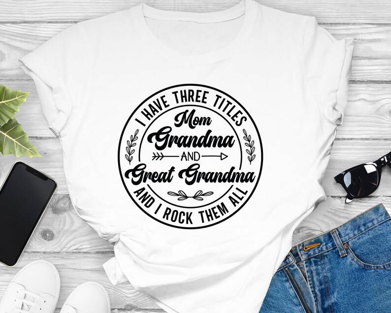 May include: White t-shirt with a black circle graphic that says "I have three titles: Mom, Grandma, and Great Grandma and I rock them all".