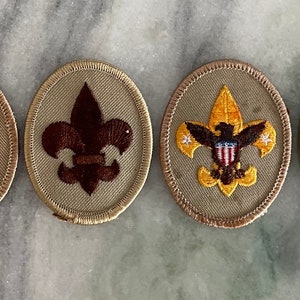 May include: Four Boy Scout patches with a beige background. The patches feature the Boy Scout emblem with an eagle and the words "Be Prepared".