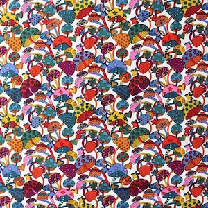 May include: A vibrant fabric featuring a repeating pattern of colorful mushrooms in shades of red, orange, yellow, green, blue, and purple. The whimsical design includes polka dots, stars, and hearts on a white background.