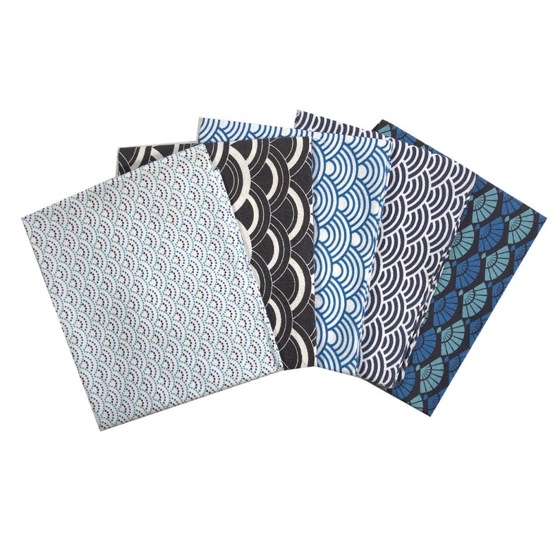 May include: Five fabric swatches with different blue and black geometric patterns. The patterns include a repeating scale pattern, a fan pattern, and a circle pattern.