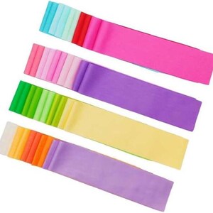 May include: Assortment of colorful ribbon rolls in various shades of blue, pink, purple, green, orange, and yellow. The ribbons are arranged in stacks and are ready to be used for crafting, decorating, or gift wrapping.