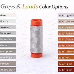 May include: A spool of silver-grey thread with bright orange plastic ends, centered between two vertical columns of color swatches labeled Greys & Lands Color Options. The list includes shades like White, Mint Ice, Airstream, Copper, and Raisin.